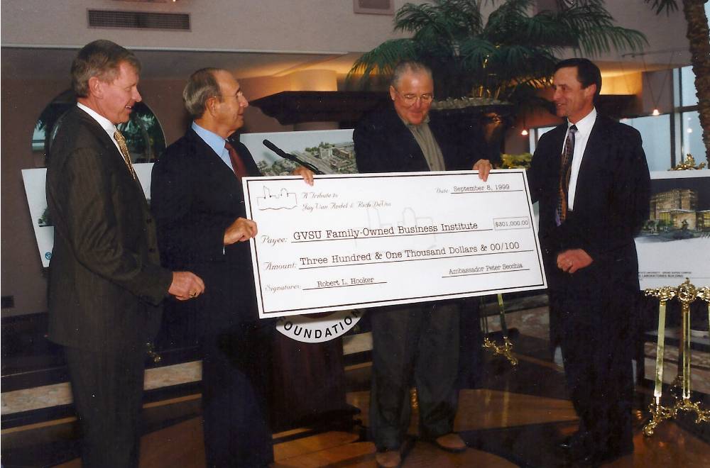 Richard DeVos with others receiving a check.
